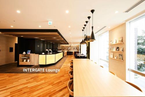 a lobby with a long table in a building at Hotel Intergate Tokyo Kyobashi in Tokyo
