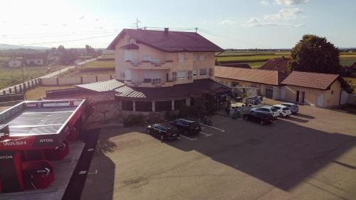 a large building with cars parked in a parking lot at Motel Atos in Laktaši