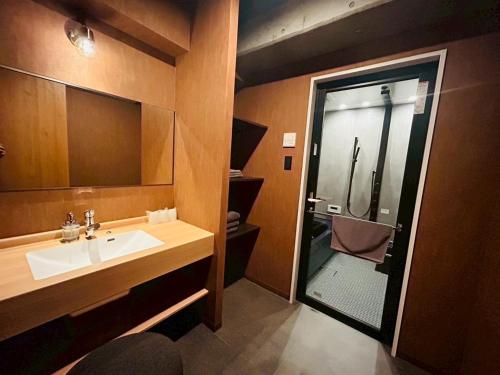 a bathroom with a sink and a shower at Casa Luce Sasebo Hotel in Sasebo