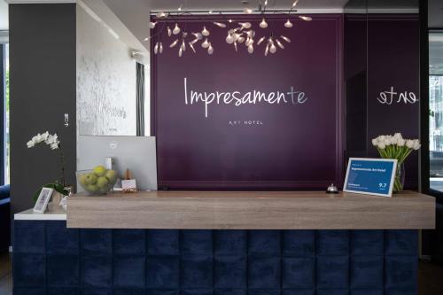 a counter with a purple wall in a room at Impresamente Art Hotel in Sofia