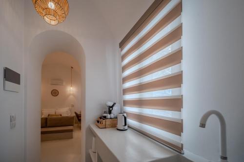 a kitchen with a wall with wooden stripes at Caldera's Elements in Santorini