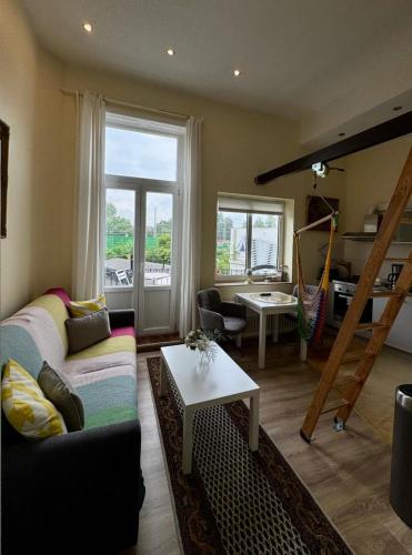 a living room with a couch and a table at Gemütliches Apartment in zentral mit Balkon in Bremen
