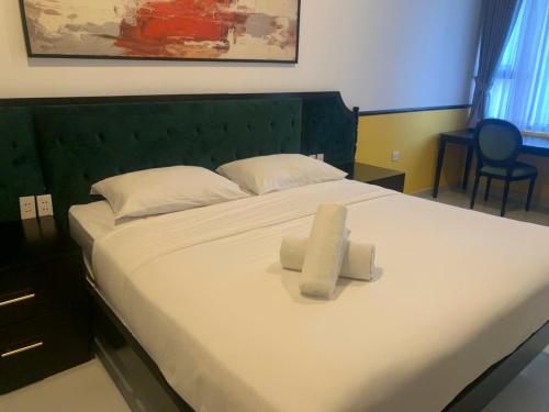a bedroom with a bed with two towels on it at NAYO Cam Ranh - Beachfront Residence in Cam Ranh International Airport