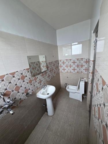 a bathroom with a sink and a toilet at Karma Bodhgaya in Bodh Gaya