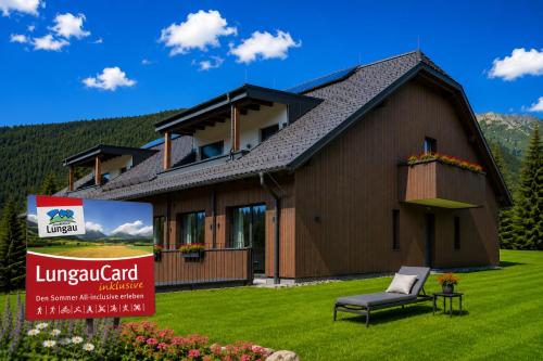 a house with a lawn in front of it at Fewo Mauterndorf in Mauterndorf