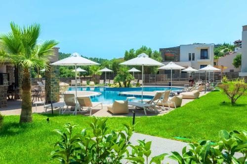 a pool with chairs and tables and umbrellas at Anẽse Vacation Feelings in Paliouri