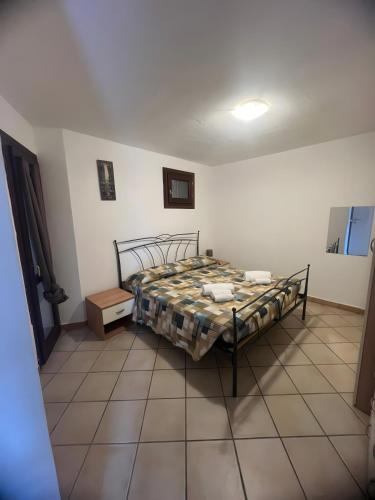 a bedroom with a bed and a tiled floor at Residence Orizzonti app n 21 in Golfo Aranci