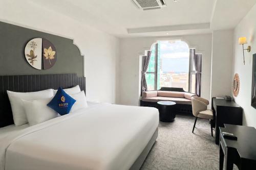 a hotel room with a large bed and a window at Sandals Everyday Hotel in Tuy Hoa