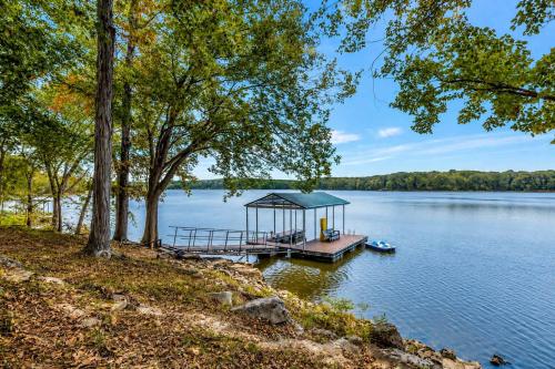 a dock with a gazebo on a lake at Hickory Haven Cozy Lakefront Escape & Dock in Cadiz