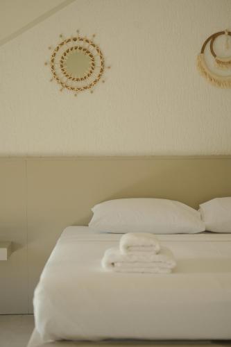 a bed with white sheets and decorations on the wall at Rua Sapanca in Sapanca