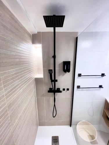 a bathroom with a shower with a toilet in it at Sweet Escape et Jacuzzi Privé in Gonesse