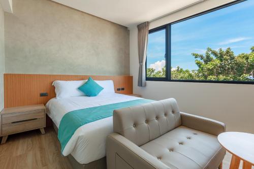 a bedroom with a bed and a large window at 消波塊民宿 in Xiaoliuqiu