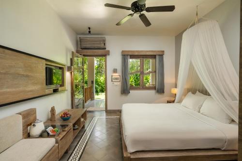 a bedroom with a bed and a ceiling fan at Sailing Club Resort Mui Ne in Mui Ne