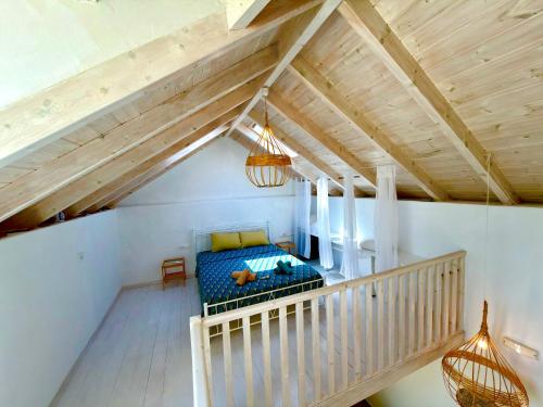 an attic room with a bed and a staircase at Cosy 21 in Ialysos
