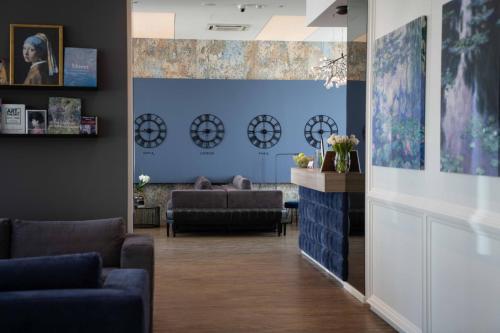a waiting room with couches and a blue wall at Impresamente Art Hotel in Sofia
