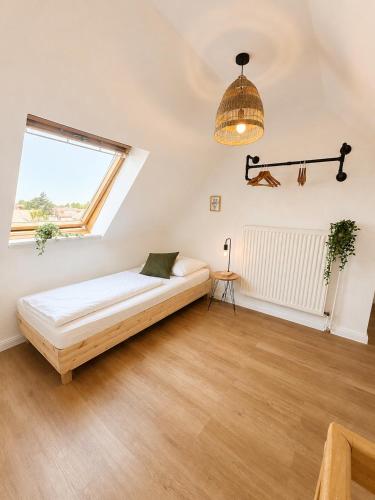 a bedroom with a bed and a window at Gasthaus Deichkieker - Wo die Nordsee dich umarmt und Erholung beginnt in Horumersiel