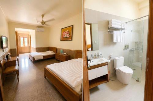 a bathroom with a bed a sink and a toilet at Bavieco Resort in Yên Bài