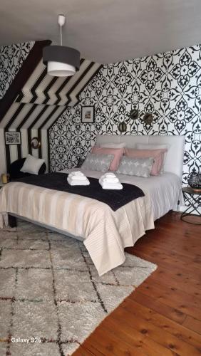a bedroom with a large bed in a room at au fil de l'oust in Rohan