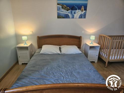 a bedroom with a bed and two nightstands with two lamps at Le grand gîte de souels in Almayrac