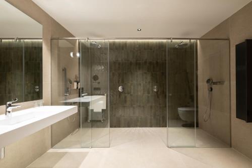 a bathroom with a shower and a sink and a toilet at Eurostars Villa Itziar in San Sebastián