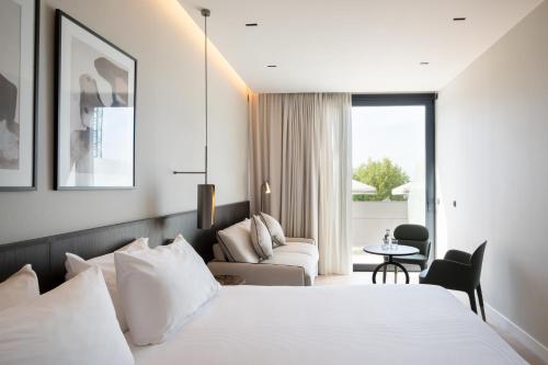 a hotel room with a bed and a couch at Eurostars Villa Itziar in San Sebastián