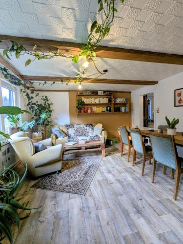 a living room with a couch and chairs and a table at Wohnung am Waldrand in Lerbach