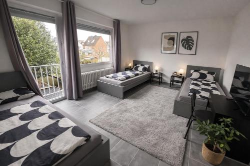 a living room with two beds and a couch at Pulheim Living 4 in Pulheim