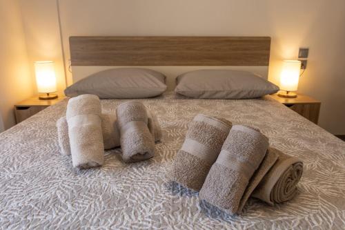 a bed with towels on it with two lamps at Casa Berardo in Megara