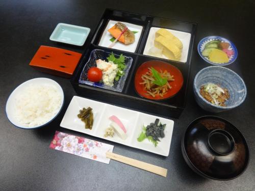 a tray of food with rice and vegetables and chopsticks at Tenryuso in Ōtaki