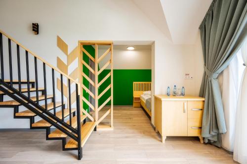 a bedroom with a staircase and a green wall at Villa Alpina Borsec in Borsec