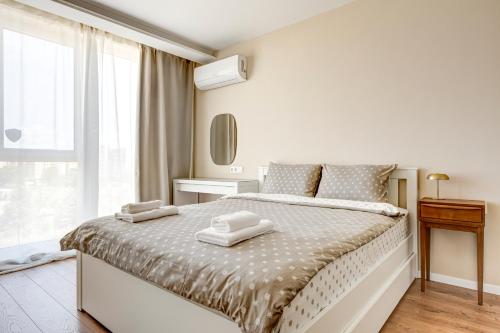 a bedroom with a bed with two towels on it at Dalia Residence - Boutique Apartment in Sofia