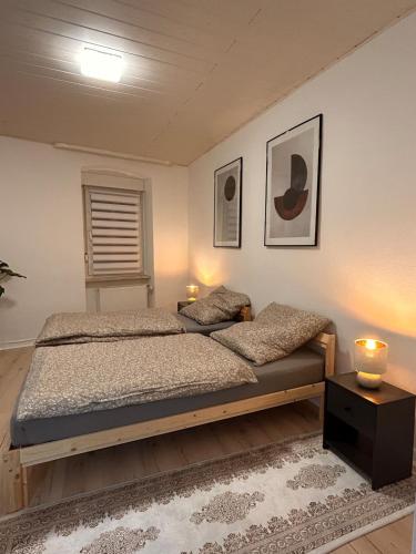 a bedroom with a bed and two candles on a table at Ferienwohnung Noela in Sankt Ingbert