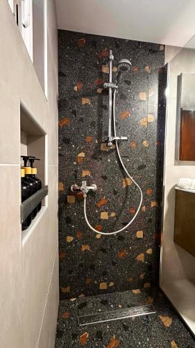 a bathroom with a shower with leaves on the floor at Sea Side House Kourouta in Kourouta