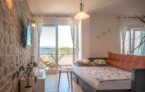 a living room with a couch and a balcony at APARTMANI Mirona - Tučepi in Tučepi