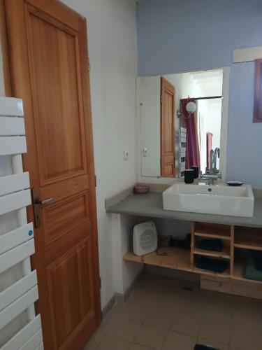 a bathroom with a sink and a mirror at Ferme de la Rose in Rosans