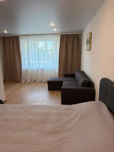 a living room with two couches and a couch at Bright & Brand New Appartment in Liepāja