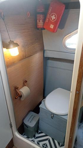 a small bathroom with a toilet and a roll of toilet paper at Petit Shetland in Liverdun