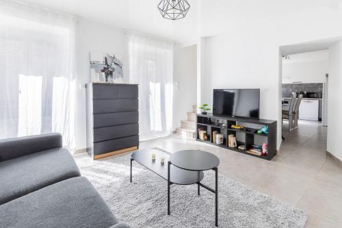 a living room with a couch and a table at Hello Flat - Maison de ville près de Paris in Athis-Mons