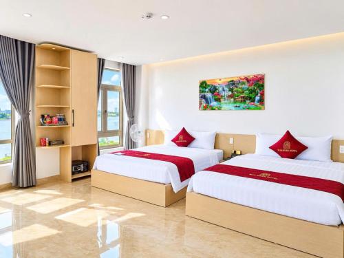 a bedroom with two beds and a window at Nhật Lệ River Hotel Quảng Bình in Huân Cát