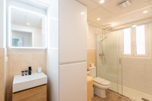 a bathroom with a toilet and a sink and a shower at Breathtaking Penthouse Las Azaleas in Torrox
