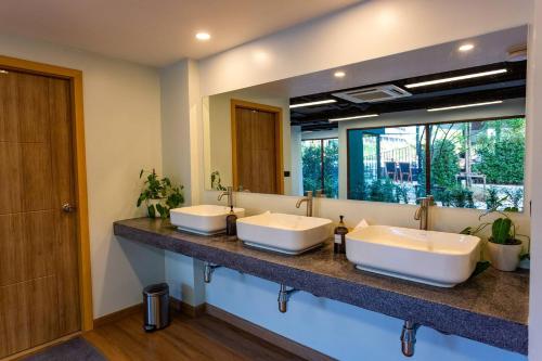 a bathroom with two sinks and a large mirror at Wing 4203 - Modern Resort Studio Koh Samui in Bophut