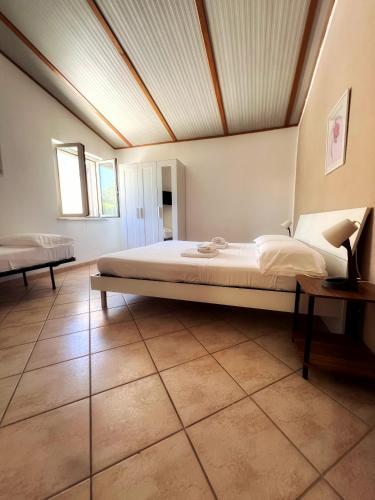 a bedroom with a large bed in a room at Quirino Residence in Gaeta