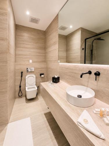 a bathroom with a sink and a toilet at Ayan Hotel in Riyadh