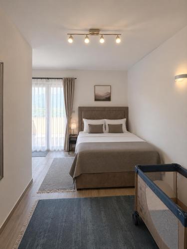 a bedroom with a large bed and a window at VN Lux Apartments in Prijevor