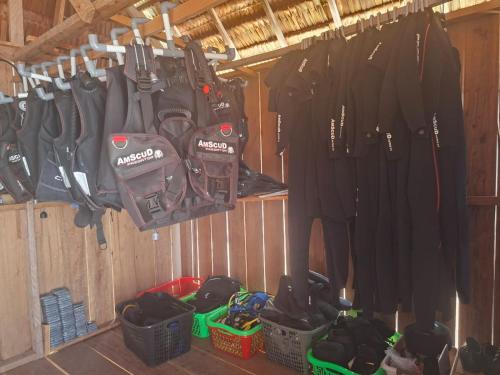 a room with a bunch of tools hanging on a wall at Kombrof Homestay & Dive Center in Waisai