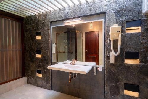 a bathroom with a sink and a mirror at Riverdale lagoon villas in Aluthgama