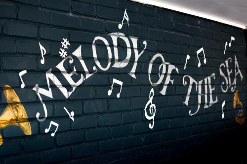 a wall with music notes painted on it at Mariaariose - "Melody of the Sea" in Bogmolo