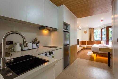 a kitchen with a sink and a counter top at Wing 4206 - Modern Resort Studio Koh Samui in Bophut