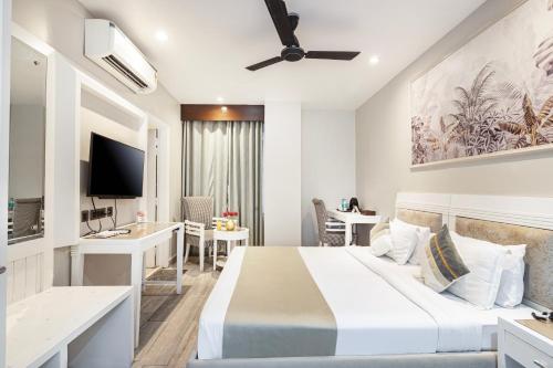 a hotel room with a bed and a desk at Skon Boutique by Orion Hotels in Delhi