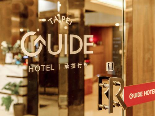 a sign on a glass door of a hotel at Guide Hotel Taipei Fuxing North in Taipei